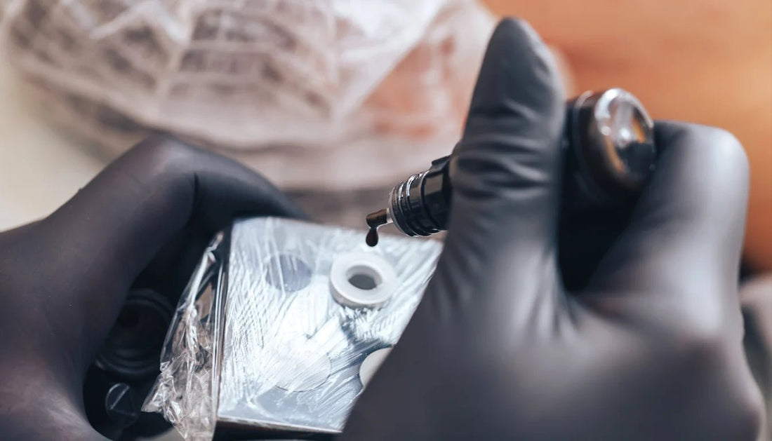 mixing black and grey tattoo ink, wearing black gloves