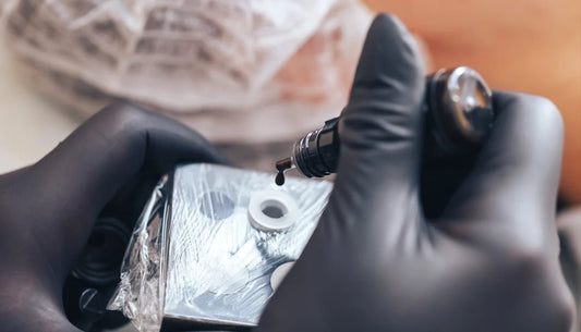 mixing black and grey tattoo ink, wearing black gloves