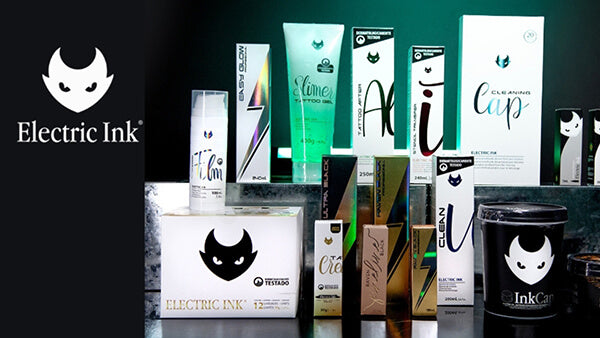 Collection of Electric Ink products including boxes and a mug on a reflective surface with a dark background.