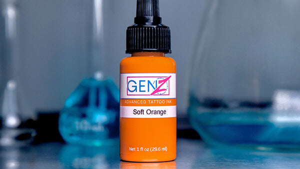Orange bottle of GENZ tattoo ink with a blurred background