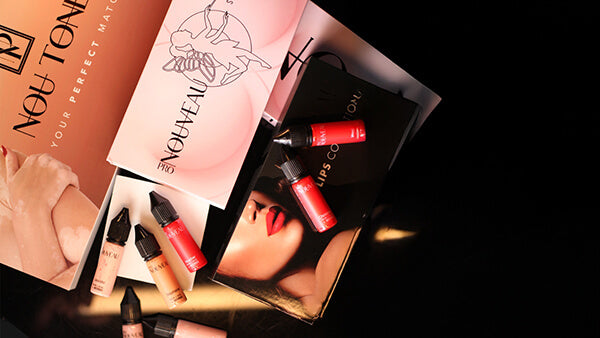 Makeup products with visible branding on a dark background
